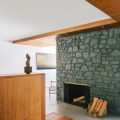 Ranch Redux - Interior view of the stone fireplace and warm wood materials. Photograph by Tomoko Matsubayashi.